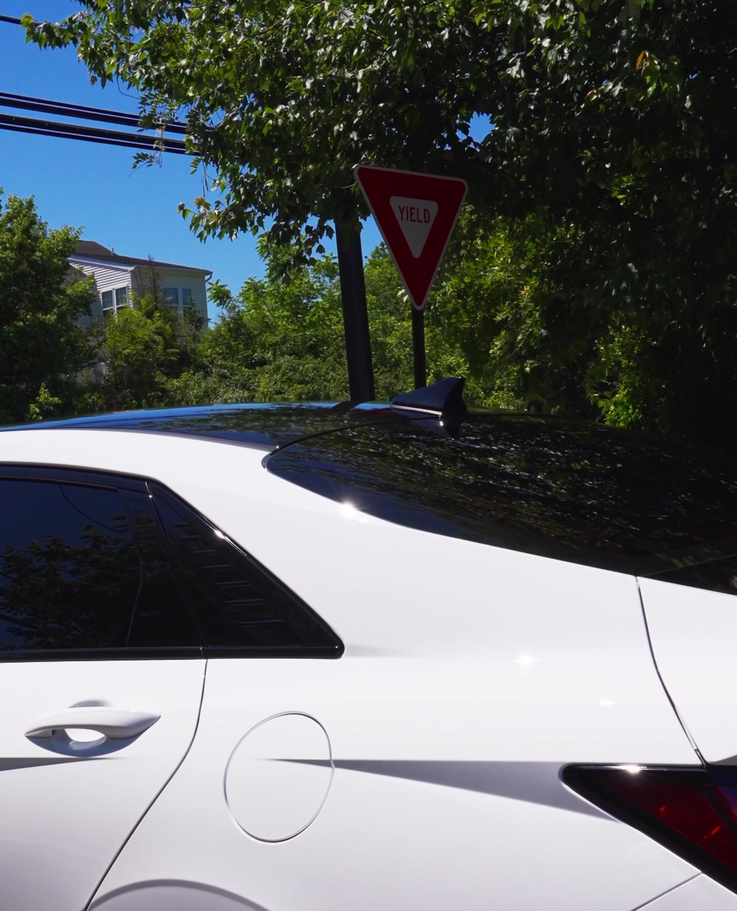 Glossy protected white performance sedan after detailing
